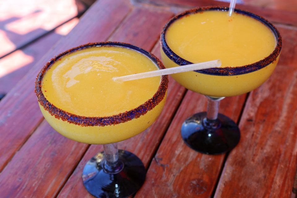 mango margarita with drinking straw on wood 655485552 5c8695a046e0fb00011366d0