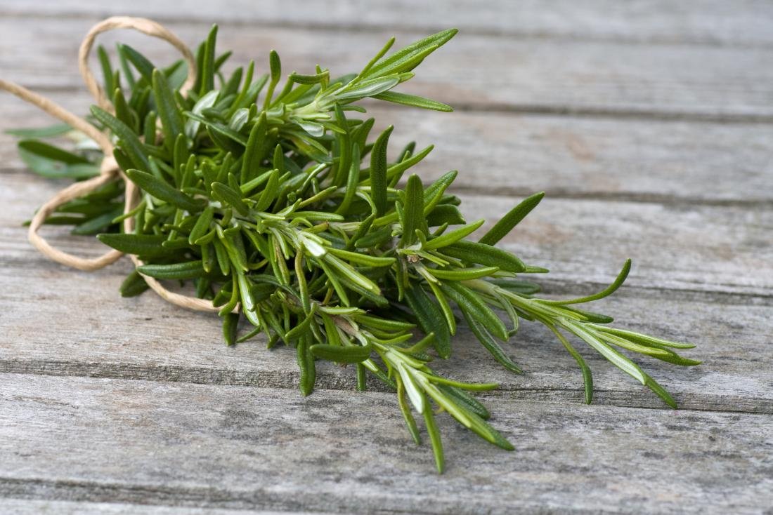 rosemary leaves bound in rope on wooden table 1