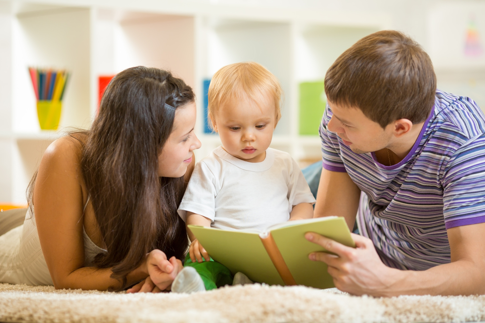 Parents reading to baby