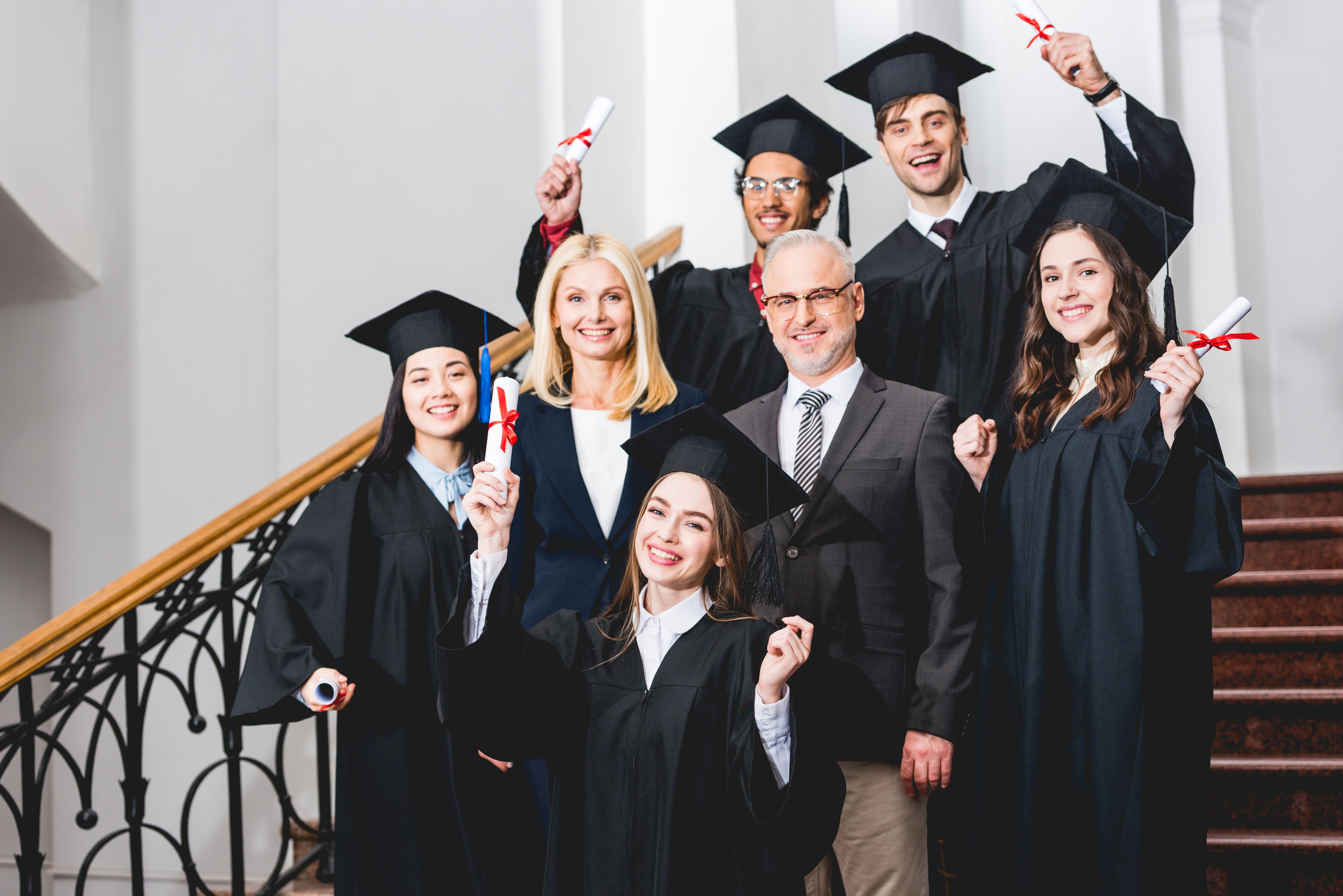 cheerful students in graduation caps holding diplo 2023 11 27 05 07 44 utc