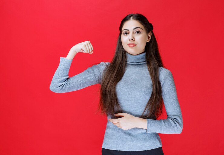 girl grey sweater showing her arm muscles 144627 64411