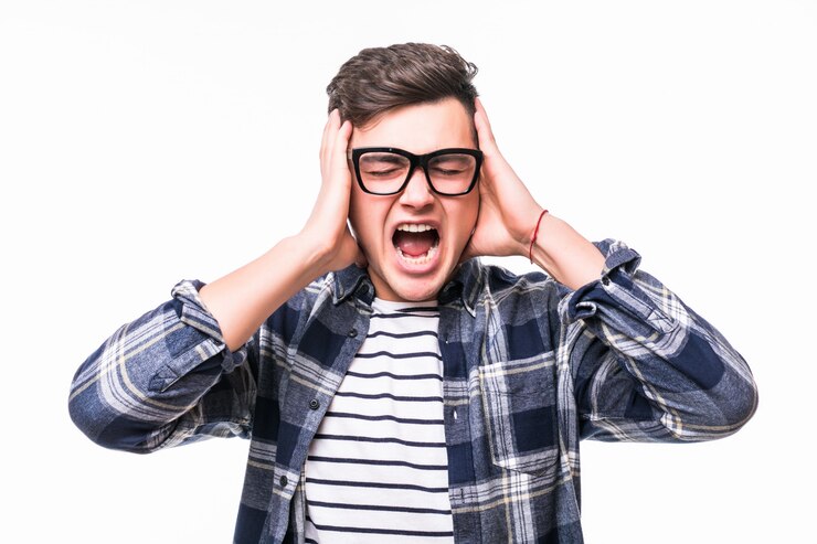 man covering his ears with hands front white wall 231208 2302