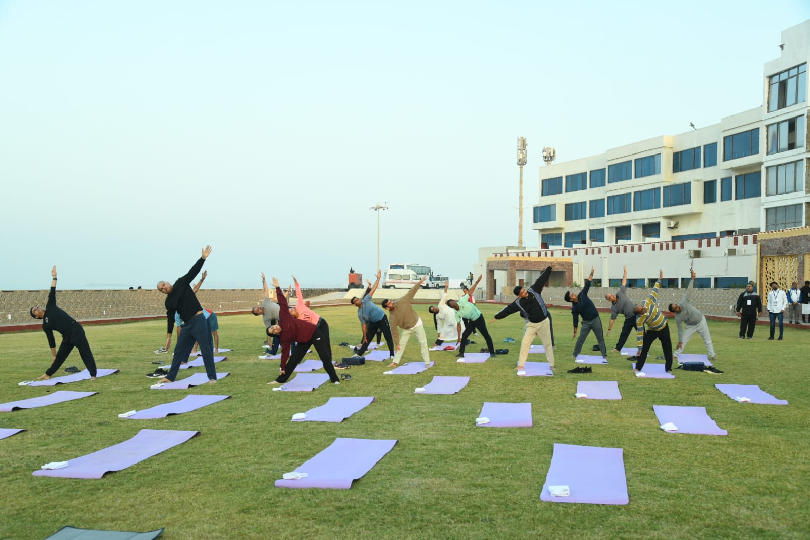 Officials begin the second day of the Chintan Shivir by doing yoga and pranayama on the beach of Somnath